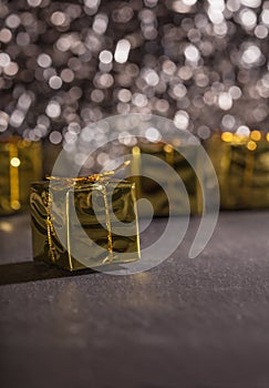 Golden present box, gift package, glitter bokeh background