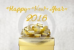 Golden Present box with Happy New Year 2016 word at bokeh light