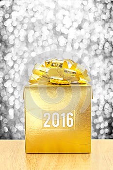 Golden Present box with 2016 word year at silver bokeh light background, Leave space for adding your text.