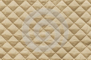 Golden quilted fabric with grained texture