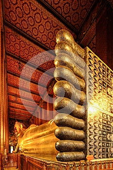 Golden reclining buddha statue at wat pho in Bangkok Thailand