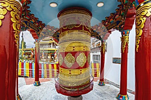 The golden and red prayer wheel at the Soma Gompa in the Indian Himalayas near the Leh Royal palace.