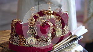 Golden religious crowns in the church. Wedding. Traditional symbols of Christianity. God, faith, marriage