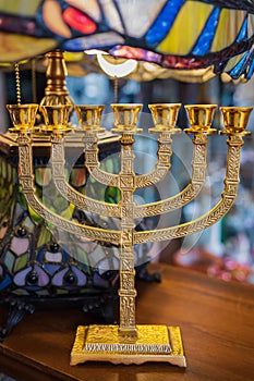 Golden religious menorah. Ancient ritual candle menorah. Hanukkah festive attribute. The Menorah is a symbol of Judaism