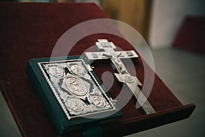 Golden religious utensils - Bible, cross, prayer book, missal. Details in the Orthodox Christian Church. Russia.