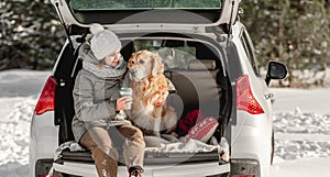 Golden retriever dog with girl in winter time