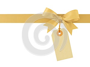 golden ribbon bow and blank beige price tag isolated on white background