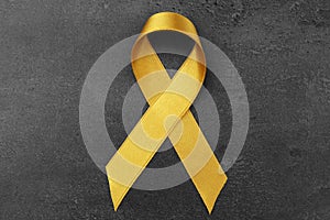Golden ribbon on dark background. Children cancer