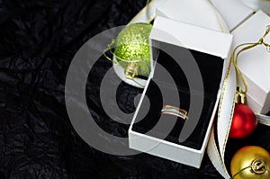 Golden ring with dimonds in white gift box