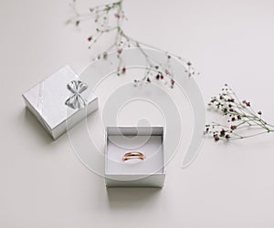 Golden ring and jewelry box and flowers. Wedding, Love, Valentine's day, Happy Birthday, Proposal of marriage concept