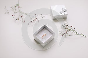 Golden ring and jewelry box and flowers. Wedding, Love, Valentine's day, Happy Birthday, Proposal of marriage concept