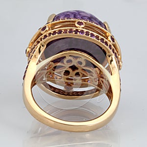 Golden ring with pink stone from back side