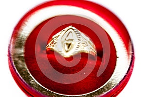 Golden ring in a red colored box isolated on white.
