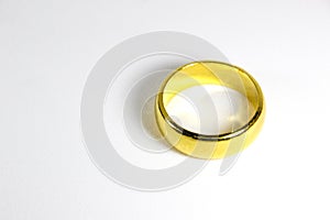 Golden ring for wedding on a white background.