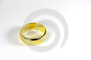 Golden ring for wedding on a white background.