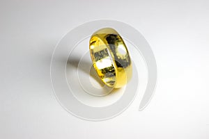 Golden ring for wedding on a white background.