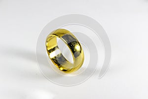 Golden ring for wedding on a white background.