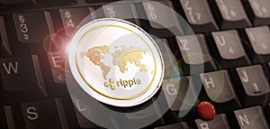 Golden ripple XRP coin over laptop keyboard