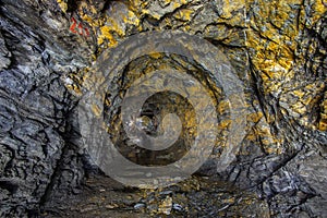 Golden rock in the old mine