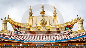 Golden roof details with Dharma wheel of Baiji or one hundred chicken Tibetan Buddhist temple Shangri-La Yunnan China