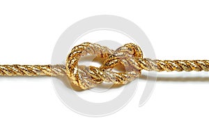 Golden rope with nautical knot isolated on white