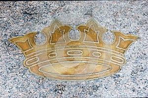 Golden royal crown on gray marble