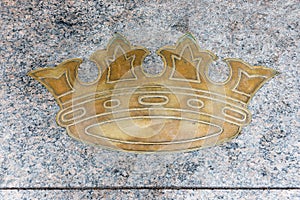 Golden royal crown on gray marble