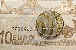 Golden RUR russian ruble coin over euro banknote macro image - depicting EU economy crisis and recession by sanctions