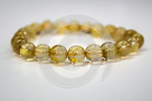 Golden Rutilated Quartz with a white background
