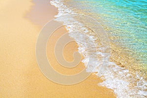 Golden sand beach, blue sea wave and white foam landscape, turquoise transparent ocean water splash, summer holidays concept
