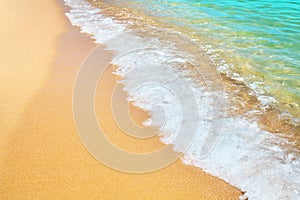 Golden sand beach, blue sea wave and white foam landscape, turquoise transparent ocean water splash, summer holidays concept