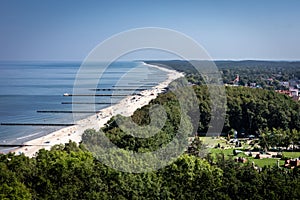 Golden sand beach with wooden breakwaters in Trzesacz, Baltic sea, Poland.