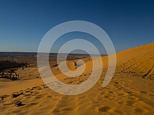 Golden sand dunes in the Algerian desert, the city of Bechar Taghit