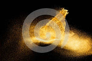 Golden sand explosion isolated on black background. Abstract sand cloud.Sandy fly wave in the air