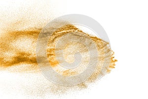 Golden sand explosion isolated on white background. Abstract sand cloud