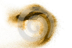 Golden sand explosion on white background.