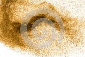 Golden sand explosion on white background.