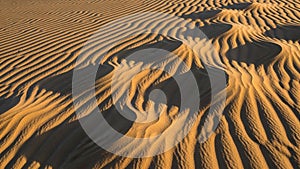Golden sand with intricate ripple patterns shaped by the wind