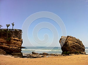 Golden sand and large rock on Biarritz beach, southern France in May