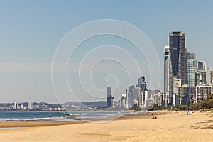 Golden sand of the Main Beach on the Gold Coast with the Surfers Paradise tourism destination city skyline in the distance, view