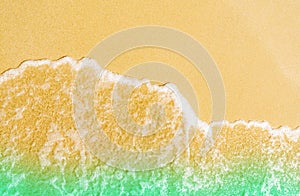 Golden sand at seaside. Sea water wave on the beach. Sand and sea water texture background.Summer vacation on tropical paradise