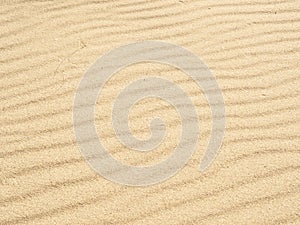 Golden sand wave texture dune background on beach. Top view