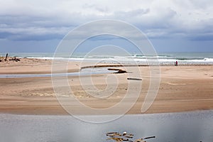 Golden Sandy Beach and Lagoon With Waves Rolling in, with Birds and 2 People at San Gregorio Reserve, Half Moon Bay, California