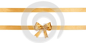 Golden satin ribbon with a bow isolated on white background.