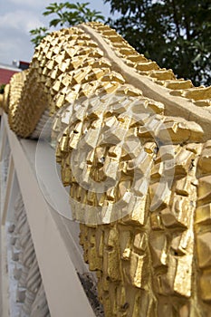 Golden scale of naga statue