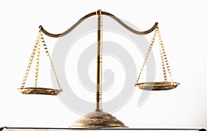 golden scales of justice in white background photo