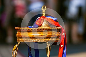 Golden school hand bell with ribbons as symbol of beginning of elementary school education for little children. Close up of ringin