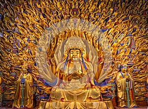 Golden sculpture of Avalokiteshvara Buddha or Guanyin with thousand hands at Dazu Rock Carvings at Mount Baoding or Baodingshan