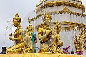 Golden sculpture man figures in fountain