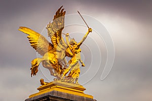 Golden Sculpture in Pont Alexandre III at cloudy day, Paris, france